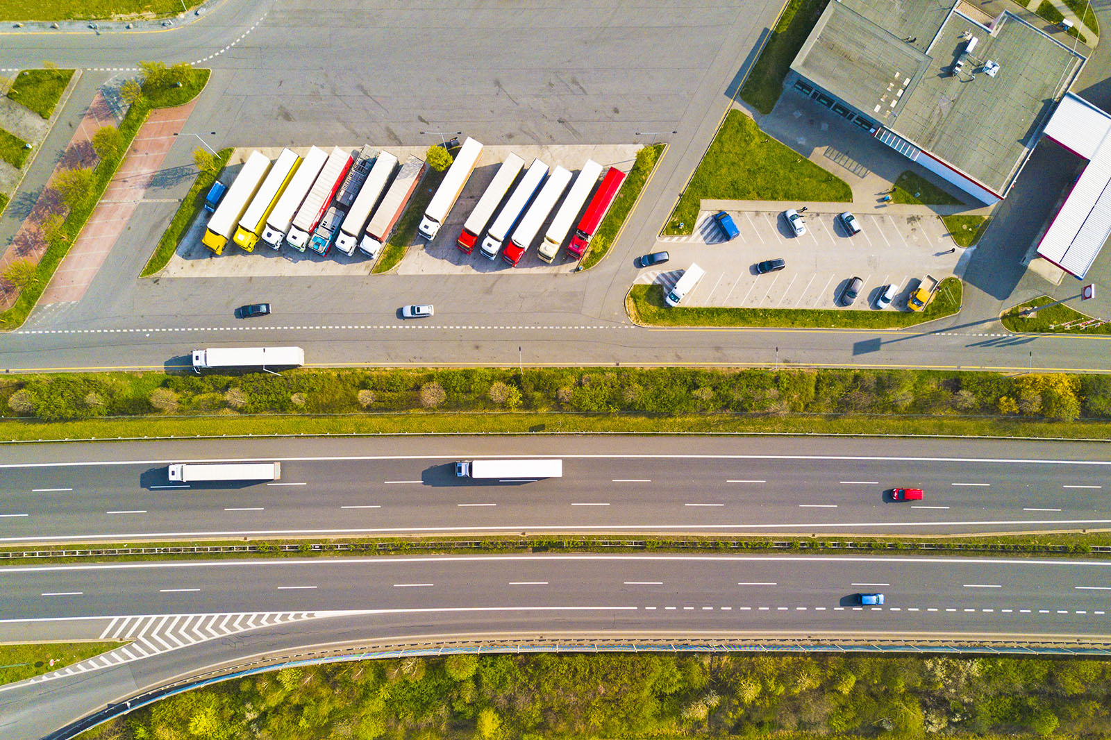 Aerial photo of highway and parking lot with trucks